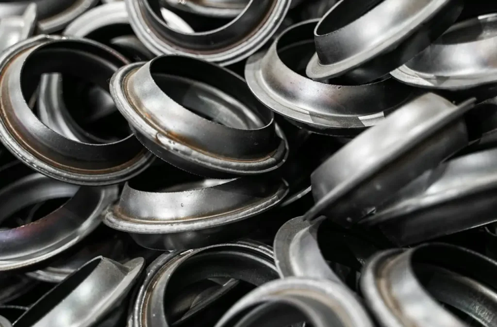 A detailed shot of metal flanges piled together, showcasing industrial precision.