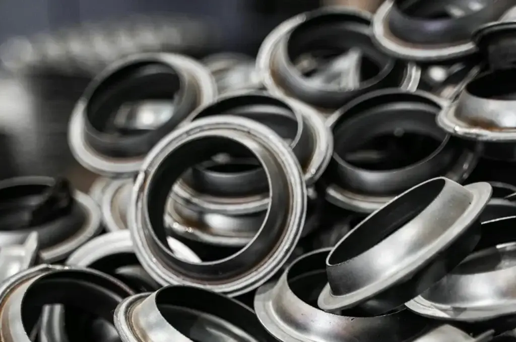 A detailed shot of metal flanges piled together, showcasing industrial precision.