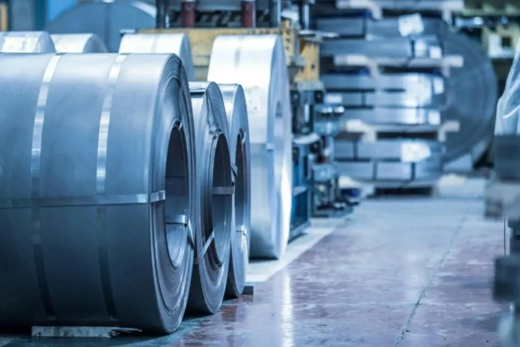 Close-up of coiled metal sheets in an industrial factory. Precision engineering materials.