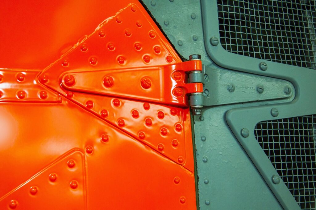 signal color, helicopter door, rivet, screws, door hinge, painted, metal, graphically, helicopter door, rivet, rivet, door hinge, door hinge, door hinge, door hinge, door hinge, painted