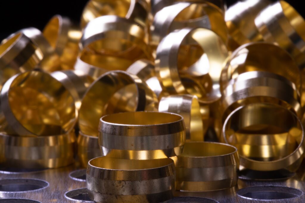 Detailed view of brass and copper rings showcasing metallic shine and industrial precision.